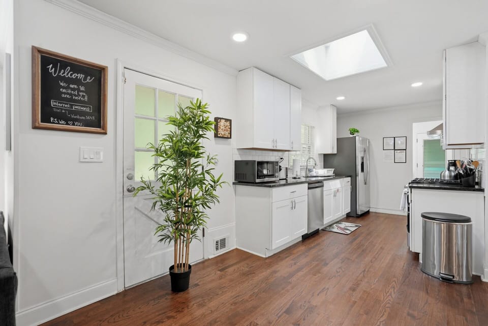 Sunny, open modern full kitchen with stainless steel appliances -MainLevel