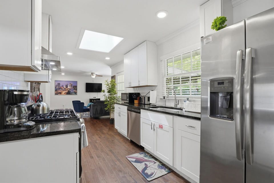 Sunny, open modern full kitchen with stainless steel appliances -MainLevel