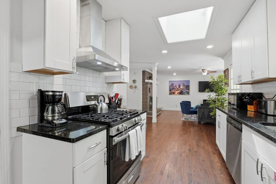 Sunny, open modern full kitchen with stainless steel appliances -MainLevel