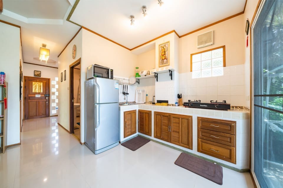The complete kitchen with utensil, stove, microwave on the 1st floor.