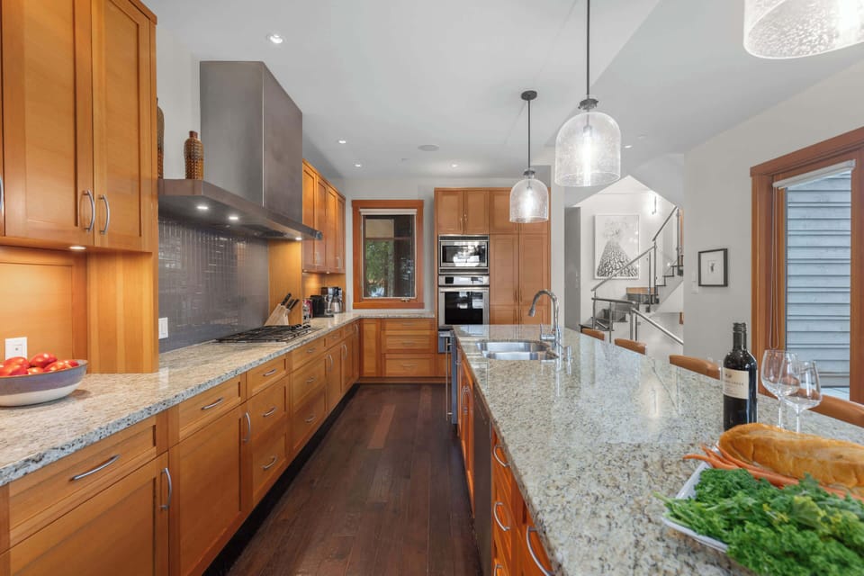 - Gourmet kitchen with granite counters and stainless appliances  
- Warm wood cabinetry and modern lighting for a polished look  
- Fully equipped for home-cooked meals and group dining  