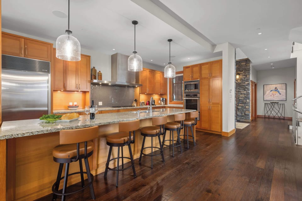 - Expansive kitchen with breakfast bar seating and pendant lights  
- Perfect setup for cooking, chatting, and dining together  
- Spacious design with easy access to living and dining areas  