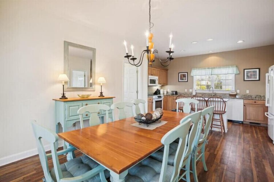 Gather around this spacious dining table for meals and conversations in a bright, welcoming space that flows into your fully equipped kitchen—perfect for creating memories.