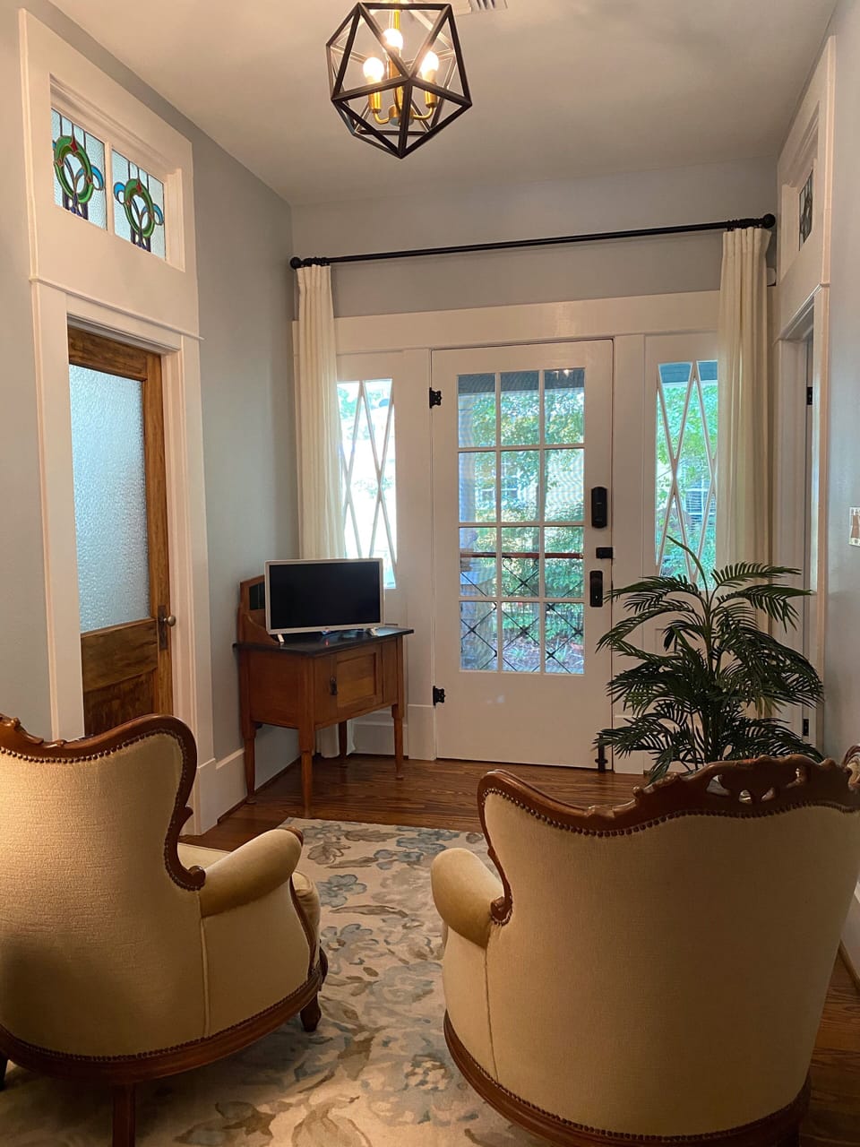 Sitting room with smart TV,  with a view out the entrance door and porch