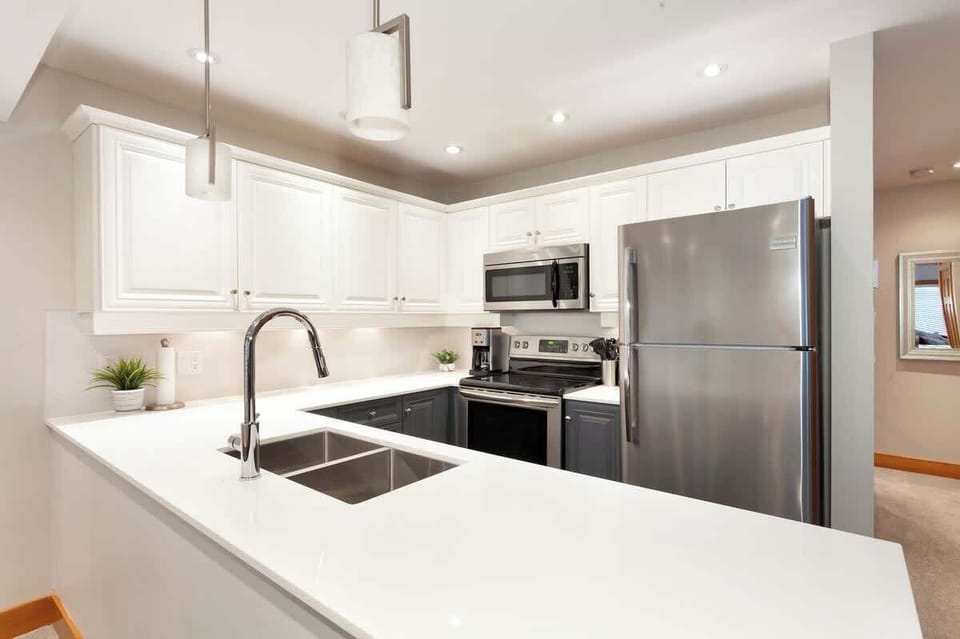 - Modern Whistler kitchen with stainless steel appliances  
- Fully equipped for gourmet cooking and cozy meals  
- Sleek countertops and open layout for social dining  
