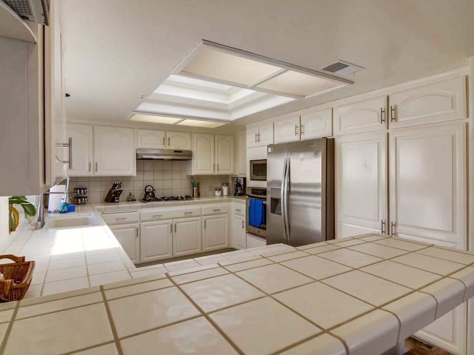 Kitchen has gas stove with hood, Oven, Microwave, Fridge/Freezer, large pantry