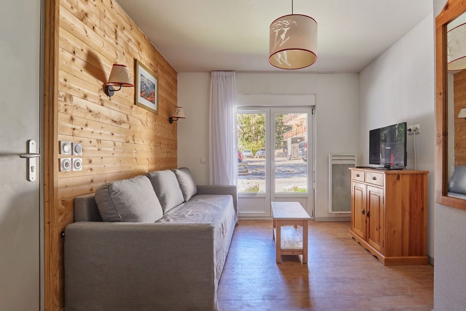 Living room with a grey sofa and wooden accents