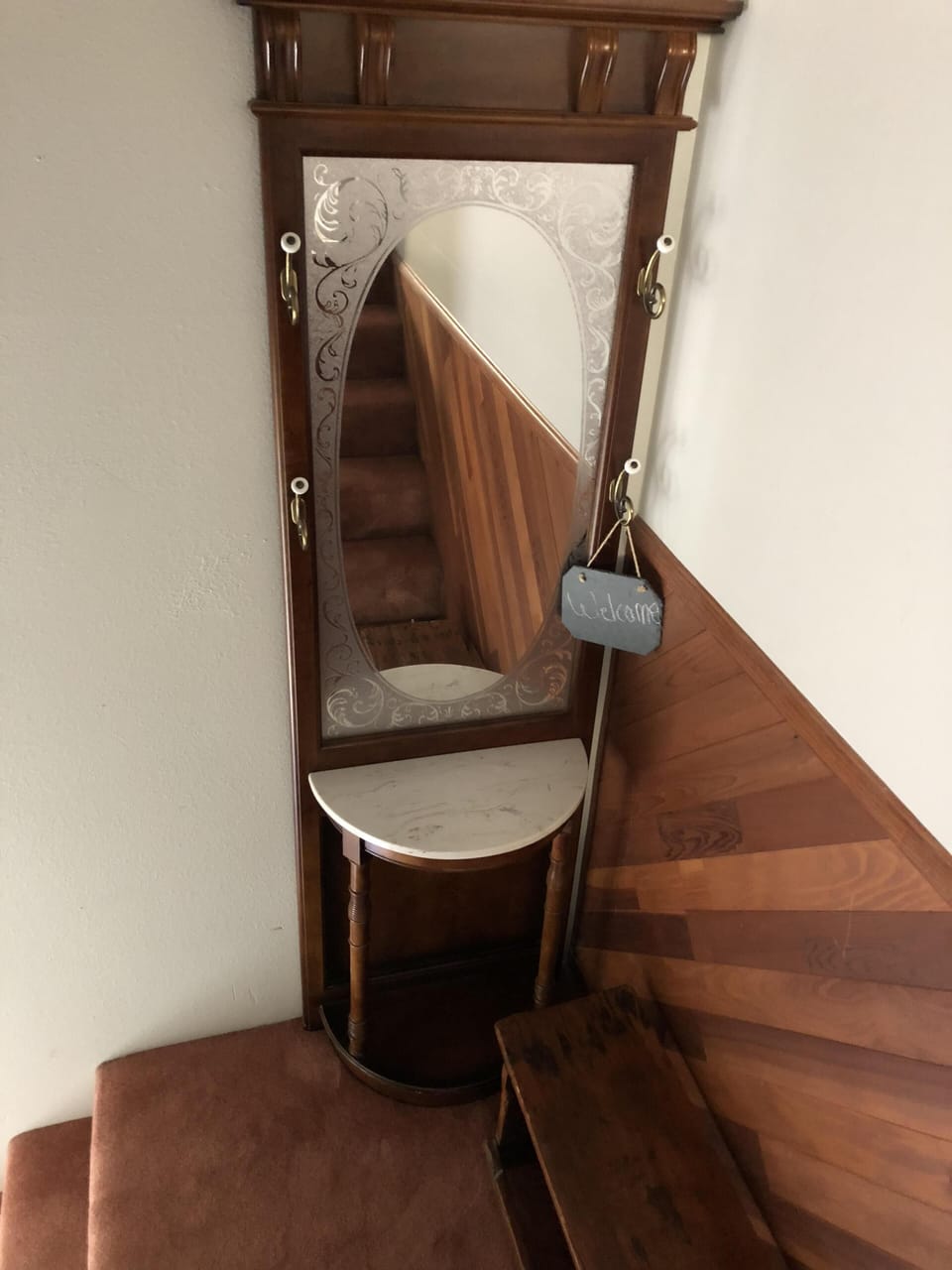Hall tree on the stairs coming up to the apartment.