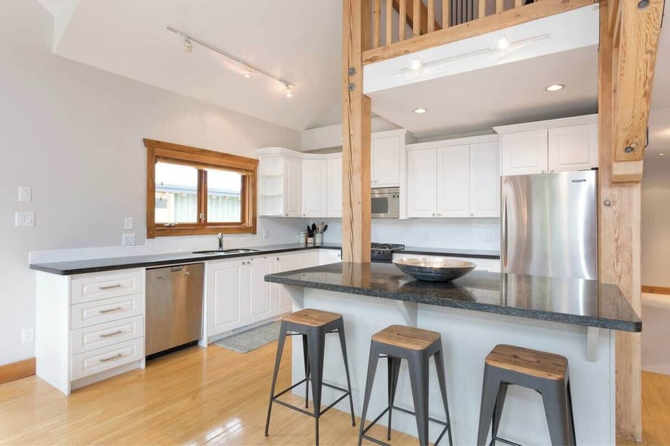 - Sleek modern kitchen with stainless steel appliances and bright design  
- Granite countertops and breakfast bar ideal for family cooking time  
- Open layout connects dining and living areas for easy flow  
