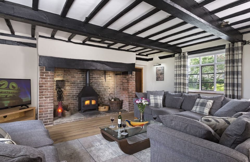Ground floor: Spacious sitting room with inglenook fireplace and wood burning stove