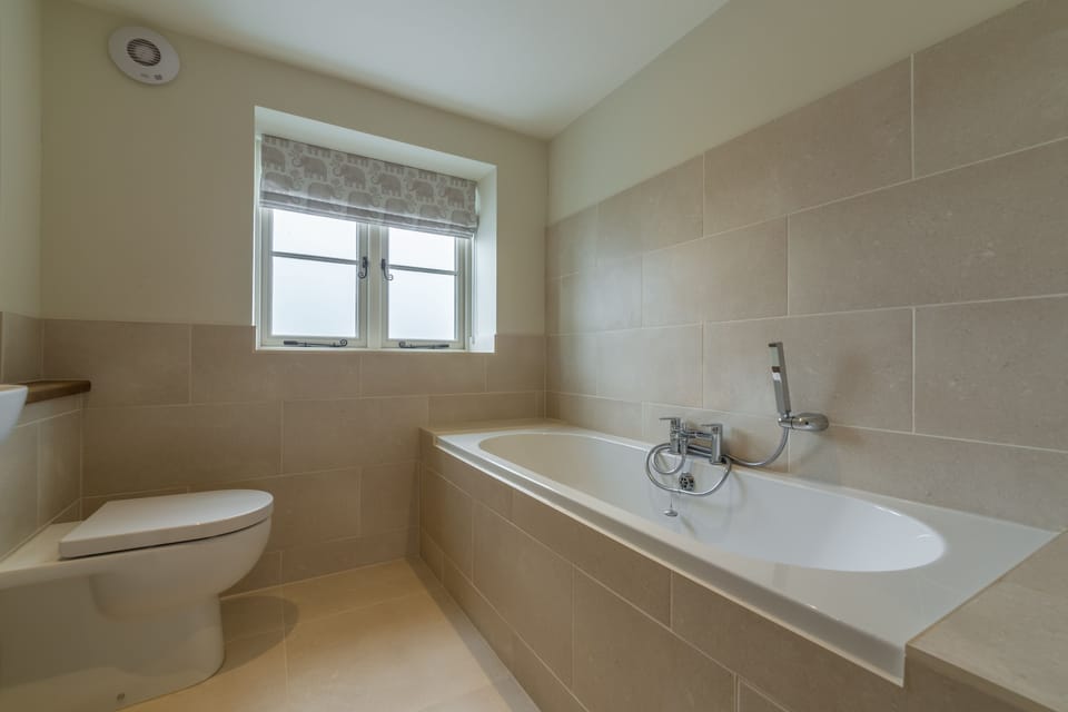 First floor: Bathroom with double ended bath and hand-held shower