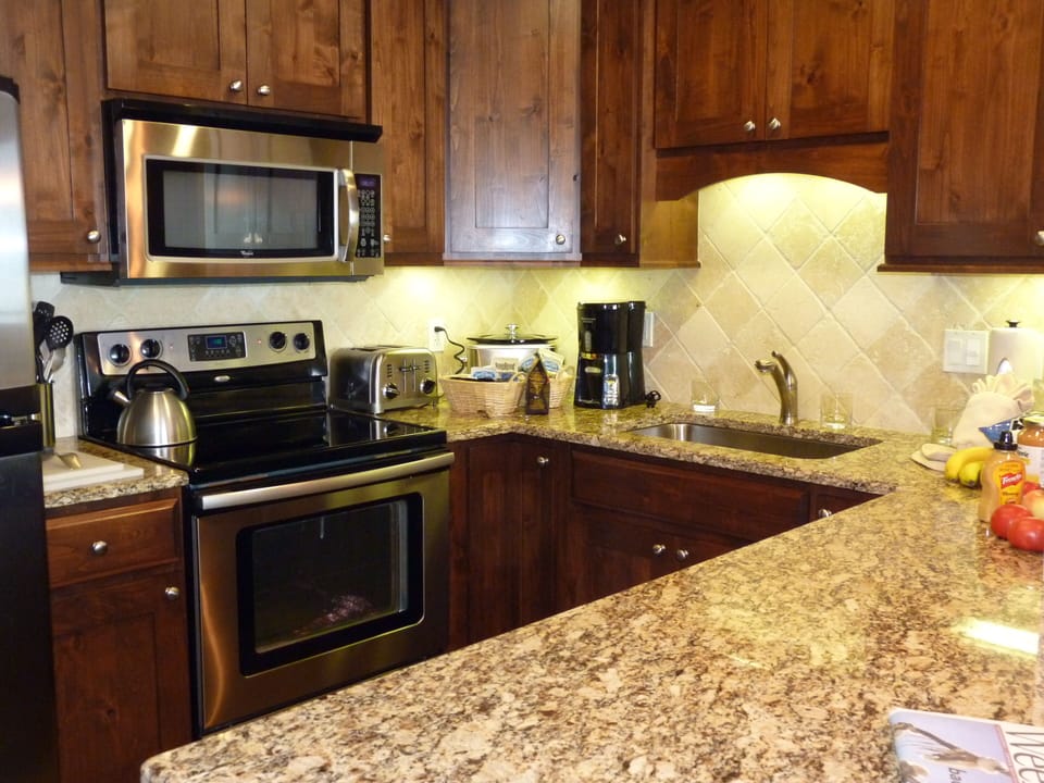 Nice kitchen and counter with bar stools - fully equipped modern kitchen
