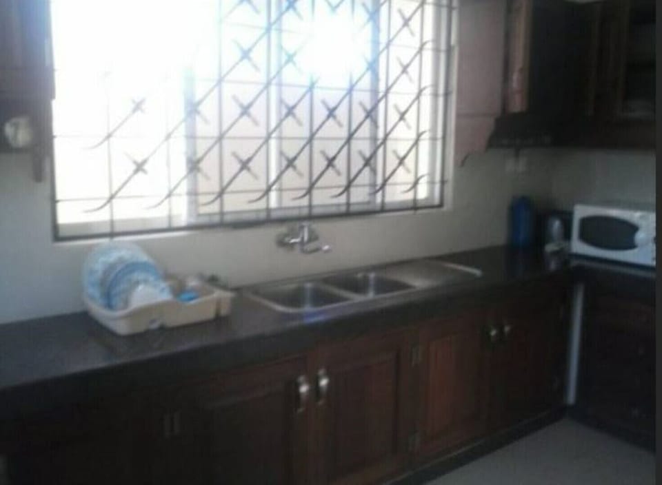 Kitchen with microwave, stove, utensils