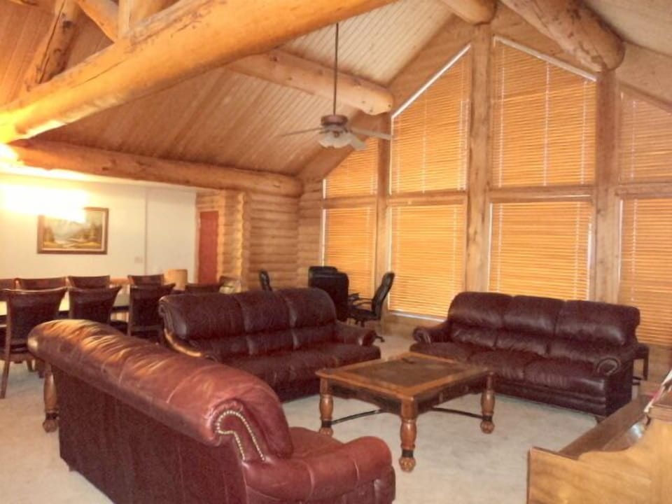 Great room with 3 leather sofas, piano and HDTV