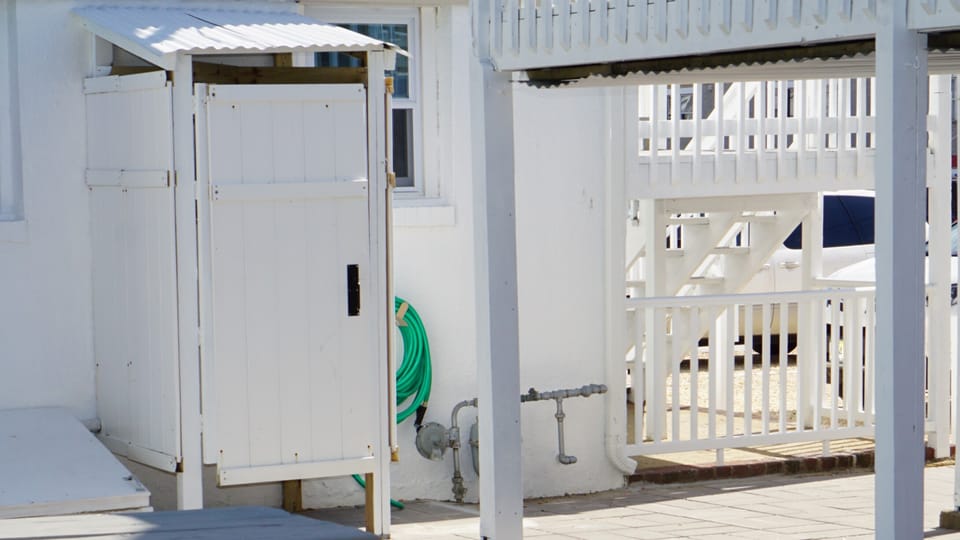 Outdoor shower for rinsing off after beach.  No waiting for public showers.
