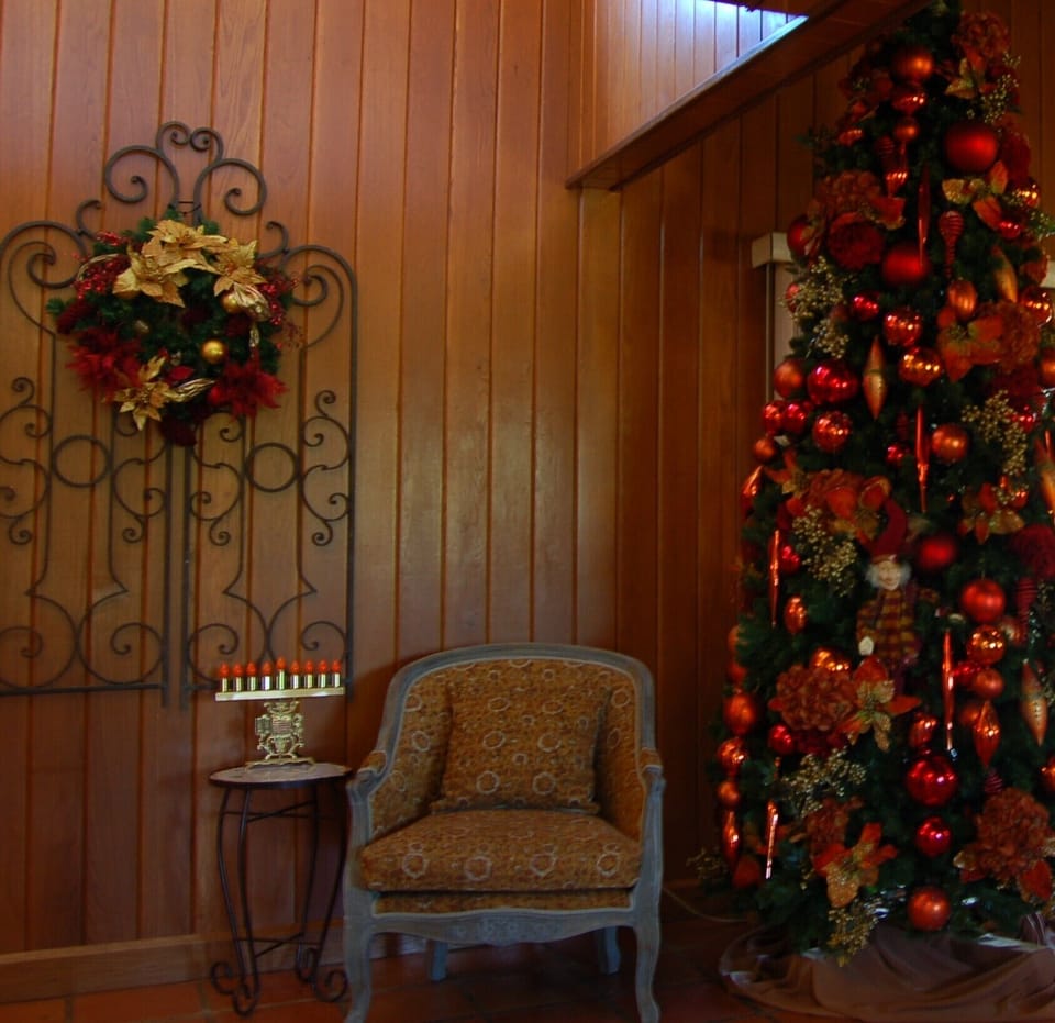 9' Christmas tree located in Carport Entry with seasonal display.
