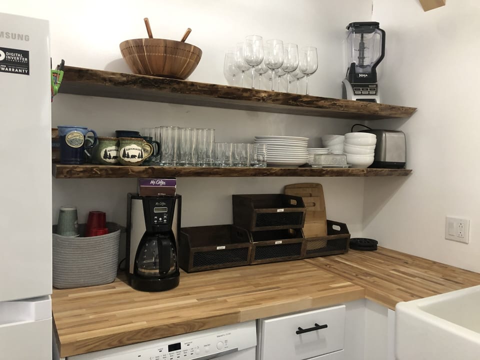 Kitchen.  Butcher block counter tops.  Custom live / raw edge floating shelves.