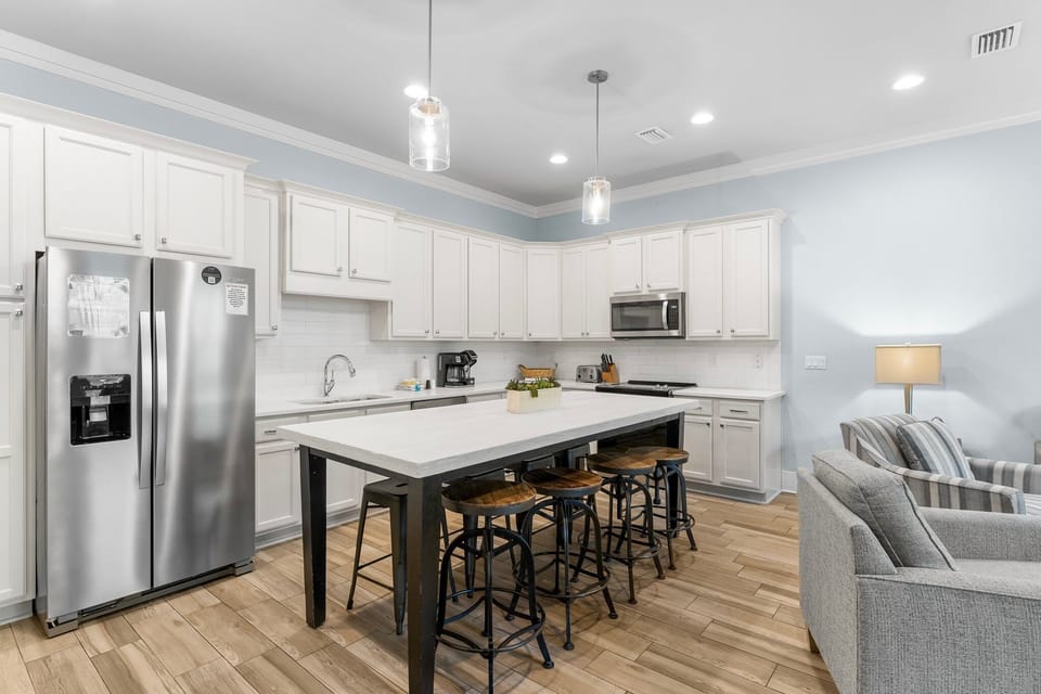 Enjoy the open-concept living and dining area with a stocked kitchen