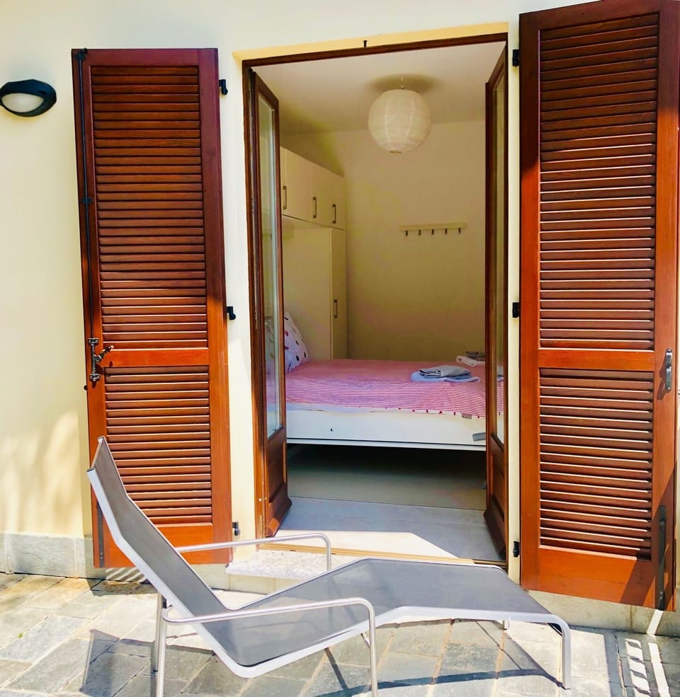 Master bedroom with adjoining lake view terrace and king sized bed