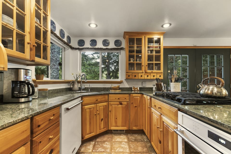 The kitchen features updated appliances, a gas range, and essential cookware.