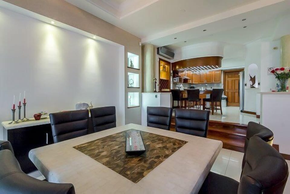 Villa Paradise has a very large dining room table.