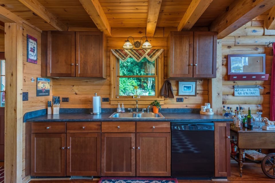 Kitchen with smooth surface stove, dishwasher, and standard coffeemaker.