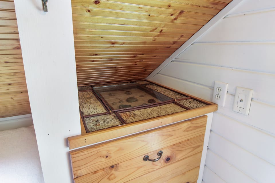 unique details. built in cabinetry/storage. wainscoting adds to cottage design