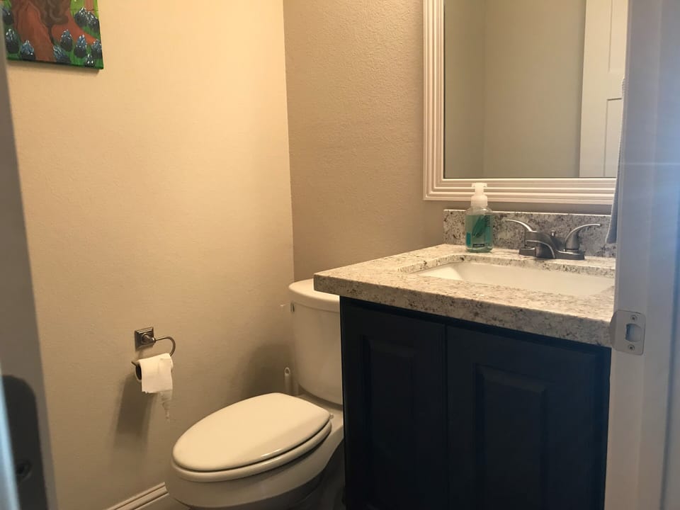 Convenient half bath off of kitchen and downstairs den