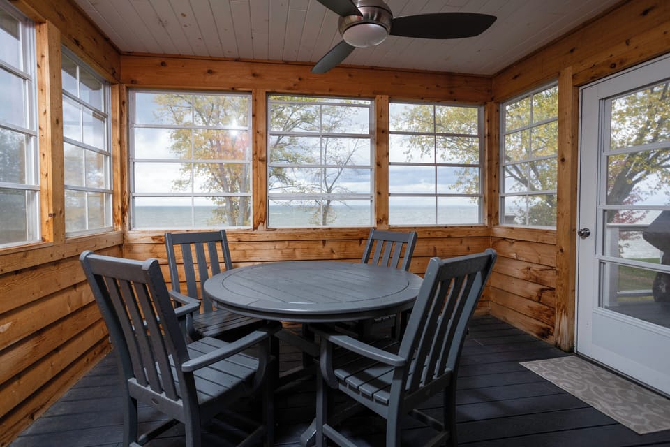 Screened in porch off the kitchen/living room with table-seating for 4