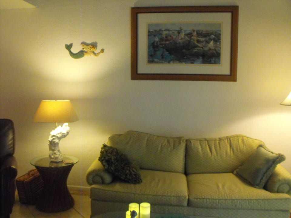 Airy living room with pull-out sofa and leather recliner to the left