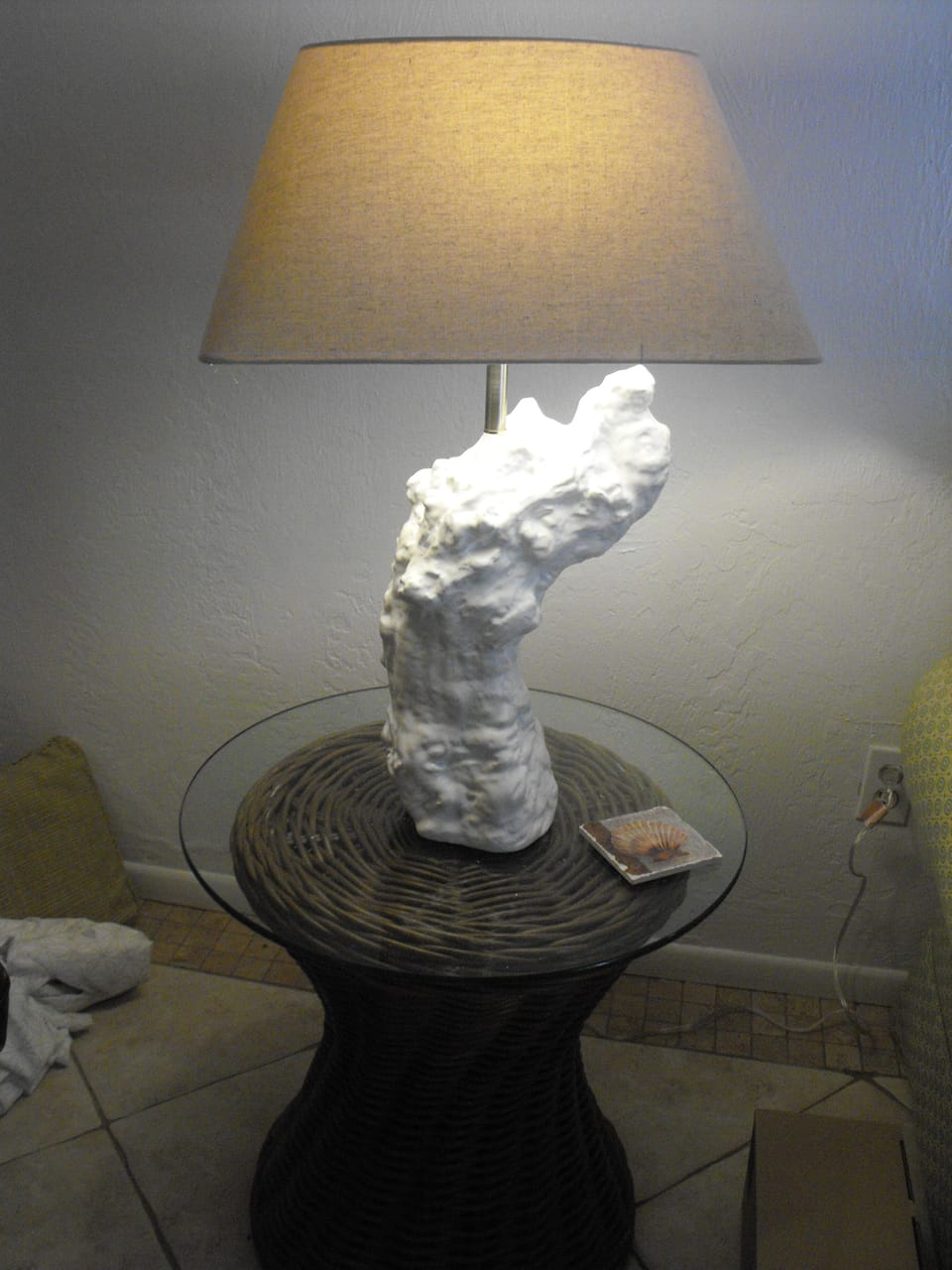 A driftwood-inspired lamp in living rm, next to comfy leather recliner at left
