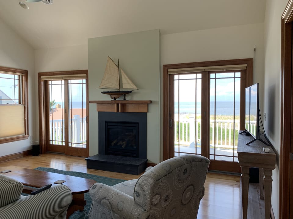  Second floor living room with fireplace and porch overlooking the bay!
