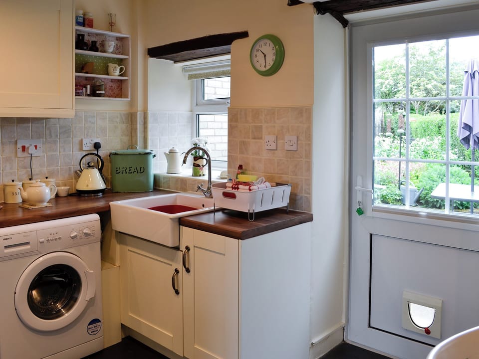 Kitchen with laundry facilities and garden access | The Bellringers Cottage, Llandegla, near Llangollen