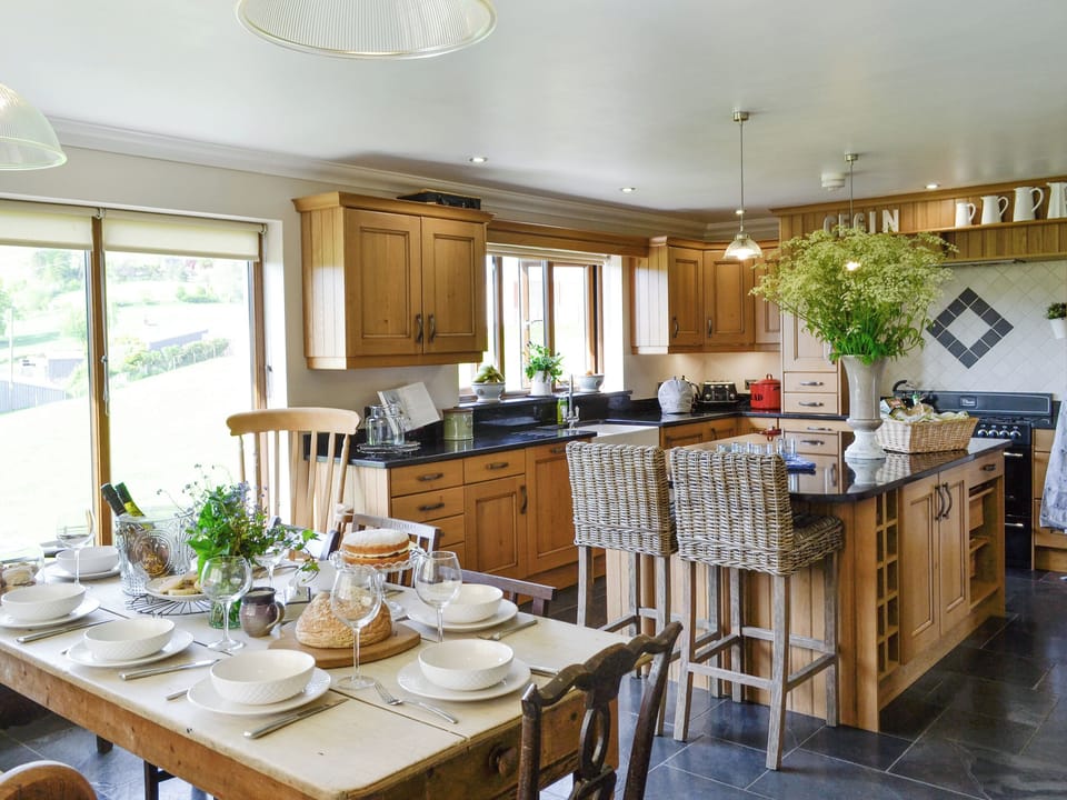 Fully appointed kitchen with dining area | Maes Y Bryn Farmhouse, Llansadwrn, near Llandeilo