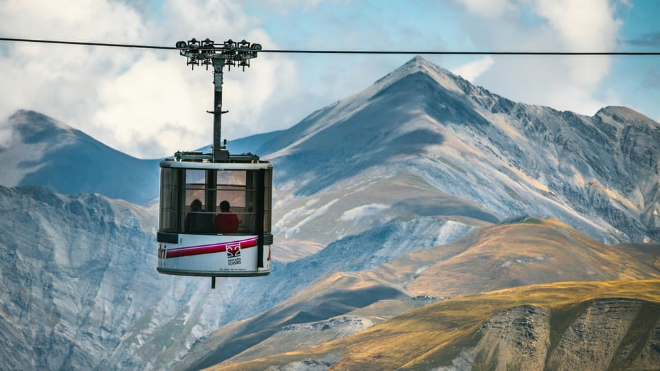 Appreciate the sweeping mountain vistas from the cable cars