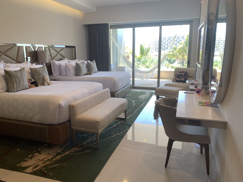 Two queen beds with luxury linens.  Accent lighting perfect for reading. 