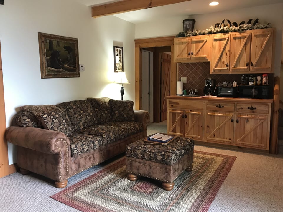 Spacious main room with TV, 2 Bunk beds and kitchenette.