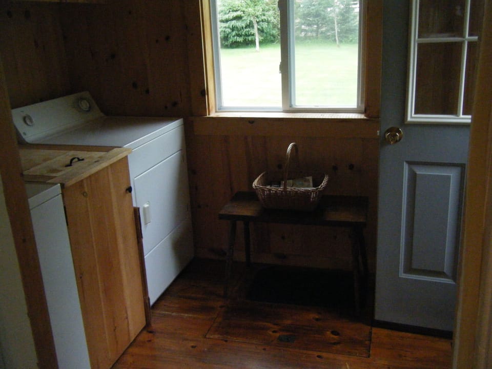 Paneled mud room with washer and dryer