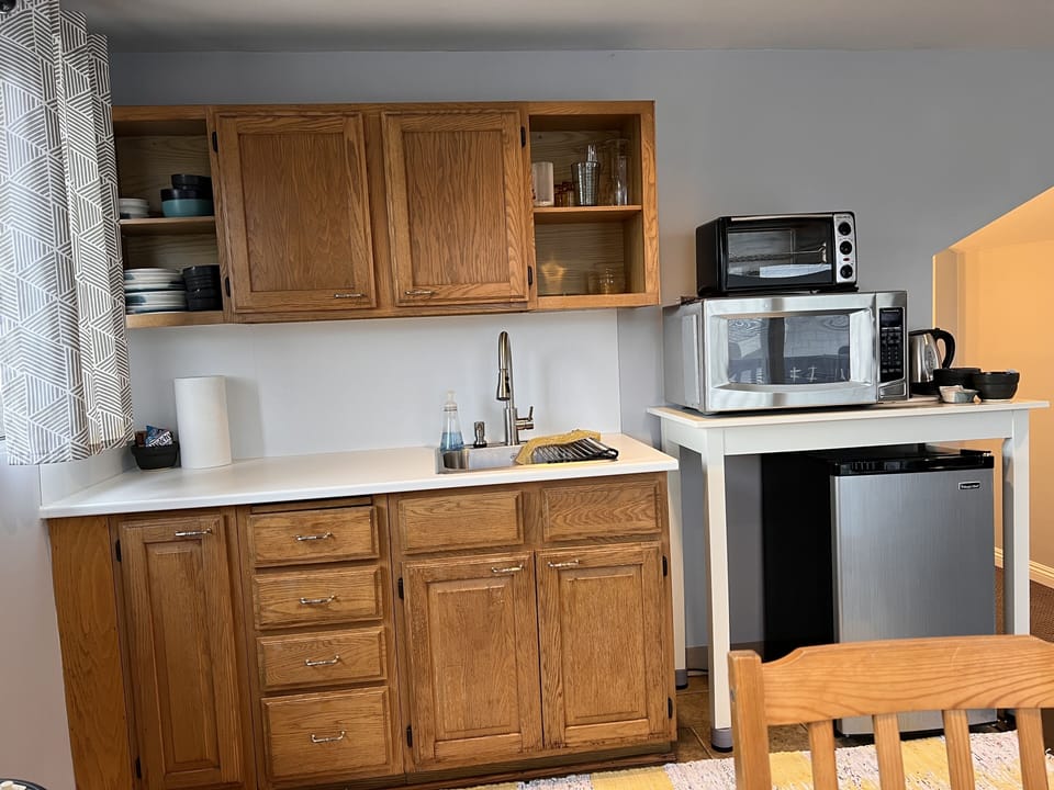 Kitchenette with toaster, microwave, mini fridge, Keurig machine & kettle