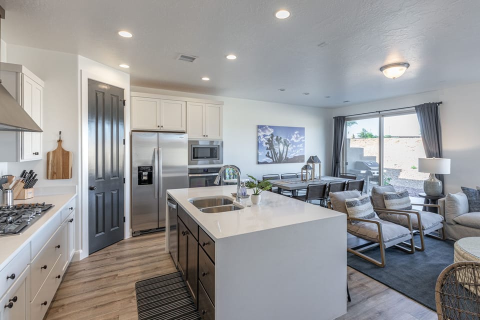 Downstairs Living Area - The living room is designed as an open floor plan and is a great gathering place for meals, games, or watching TV during your stay.