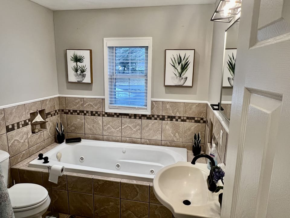 Rejuvenate in the main floor bathroom w/ Jacuzzi tub and stand-up shower!