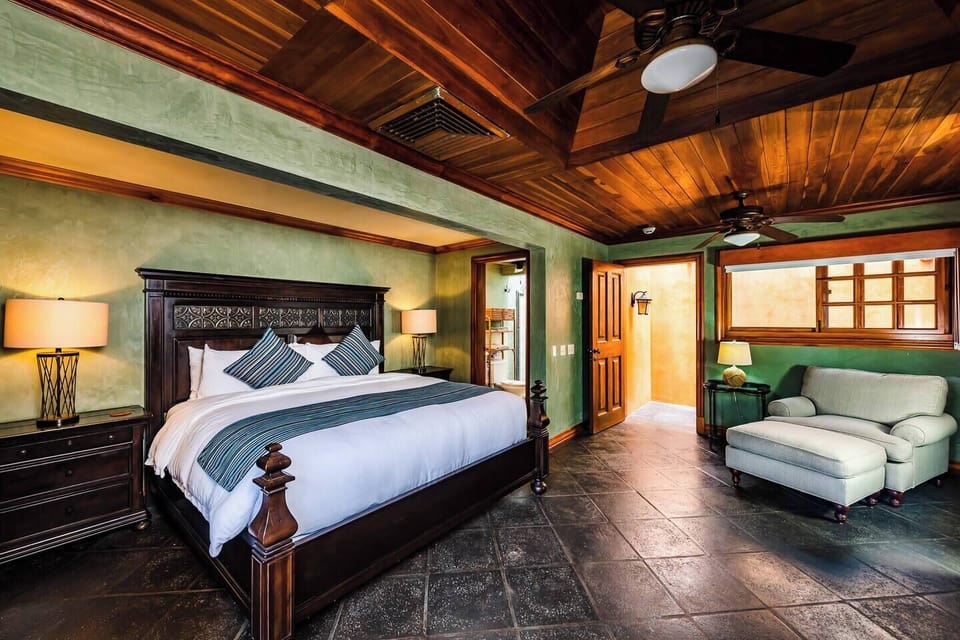 King-size guest bedroom in this Tamarindo beachfront villa, featuring stylish décor, air conditioning, and a peaceful retreat for a perfect family vacation or getaway.