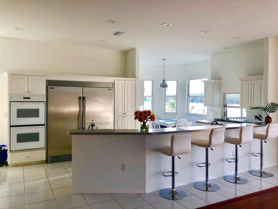 Kitchen area with oversized / modern refrigerator.  