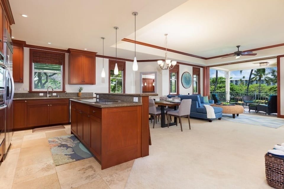 Full kitchen with breakfast bar, granite counters, and stainless steel appliances