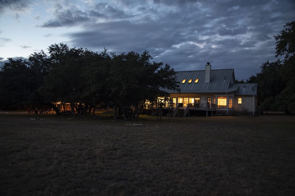 The rear of house at dusk from the pasture.