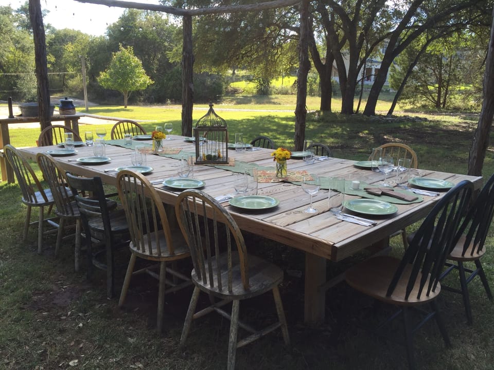 Outdoor dining table under the lights can seat up to 18.