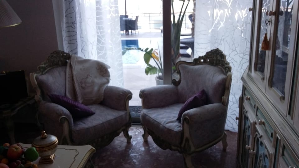 A view of the terrace with the Pool and Sun loungers
