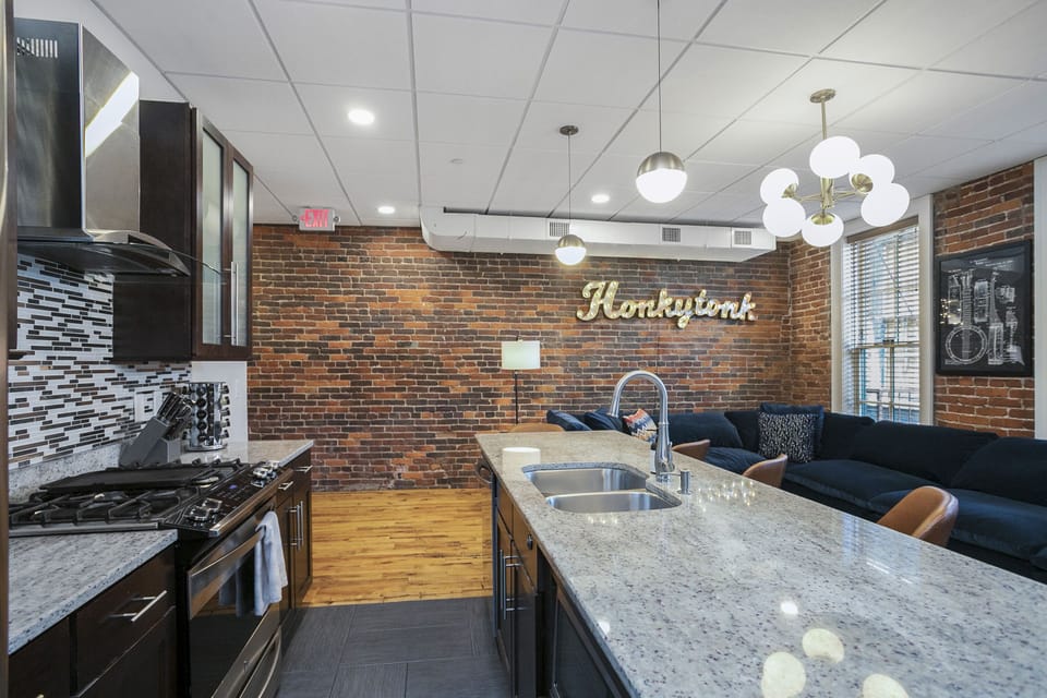 - Open kitchen view with granite countertops enhancing your Nashville getaway - Modern finishes brick accents and bright lighting create welcoming comfort - Ideal for cooking relaxing and gathering throughout your stay