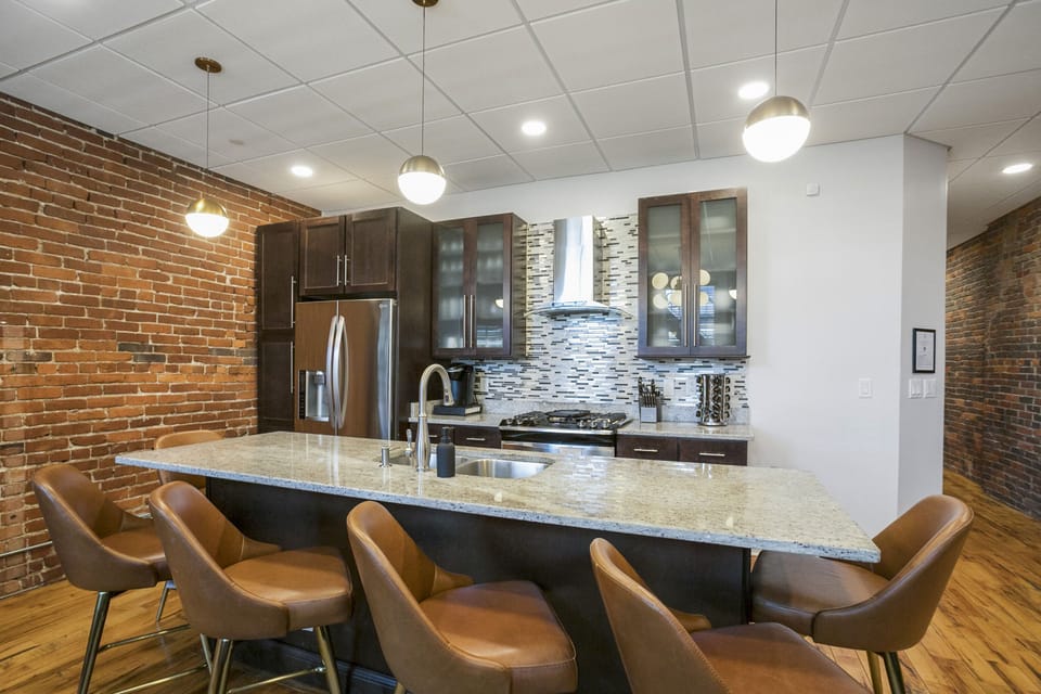 - Modern kitchen with granite island seating perfect for hosting and dining - Stainless steel appliances and sleek cabinets add comfort to your Nashville stay - Open layout makes cooking and gathering easy for groups and families