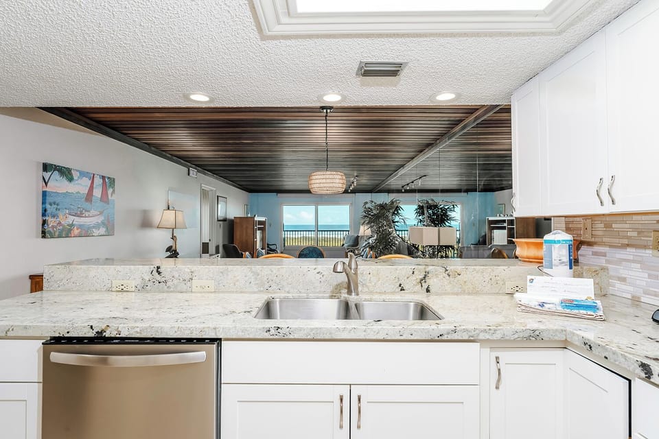 Washing dishes with a beach view is like trying to have a dance party while being stuck in rush hour trafficâ€”it's hard to focus on the suds when all you want to do is dive into the waves!